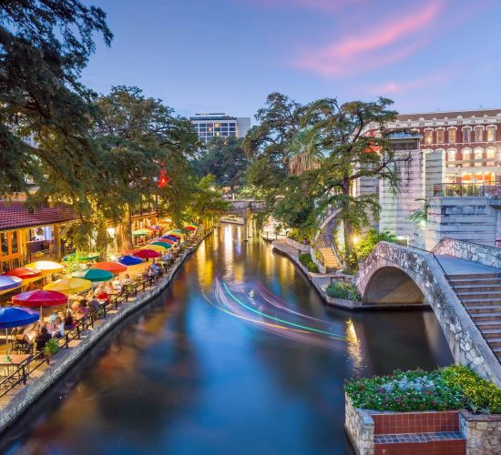 River walk in San Antonio city downtown skyline cityscape of Texas USA at sunset