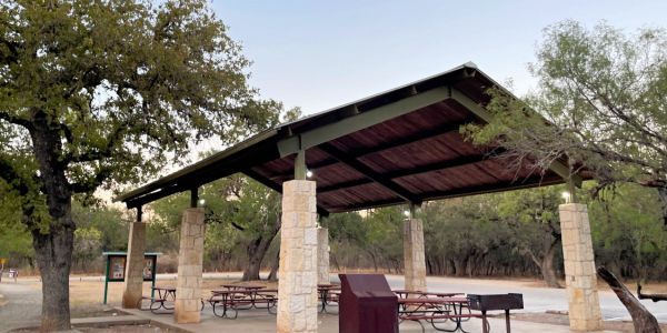 Covered pavilion with picnic tables at a park in San Antonio near La Calera Apartments.