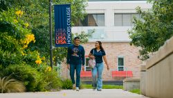 Students walking on UTSA campus in San Antonio near La Calera Apartments